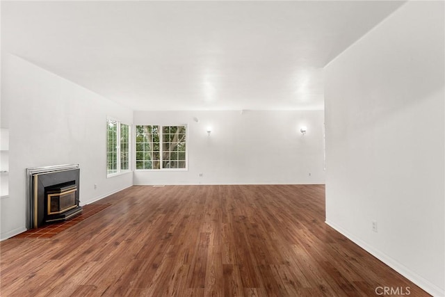 unfurnished living room featuring dark hardwood / wood-style flooring