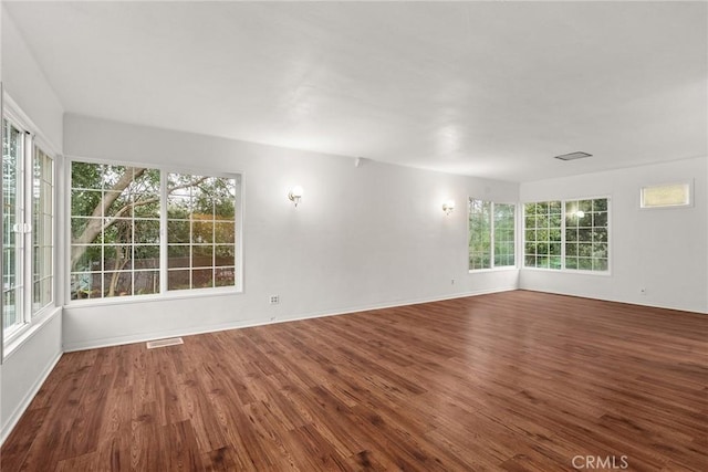 unfurnished room featuring hardwood / wood-style flooring