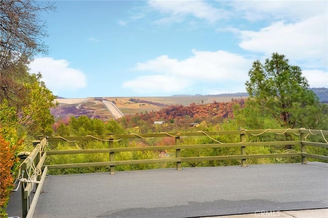 view of gate with a mountain view and a rural view