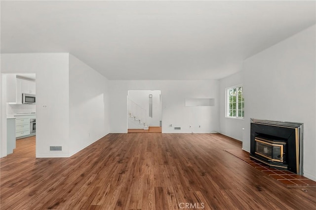 unfurnished living room with dark wood-type flooring