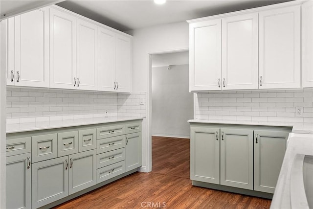 kitchen featuring dark hardwood / wood-style floors, white cabinets, and decorative backsplash