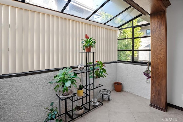 sunroom / solarium featuring a skylight and a healthy amount of sunlight