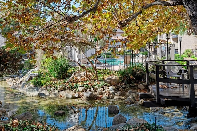 view of home's community featuring fence and a wooden deck