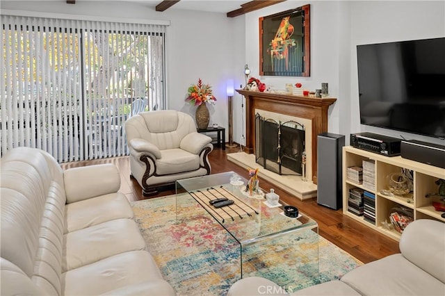 living room featuring hardwood / wood-style floors and beamed ceiling