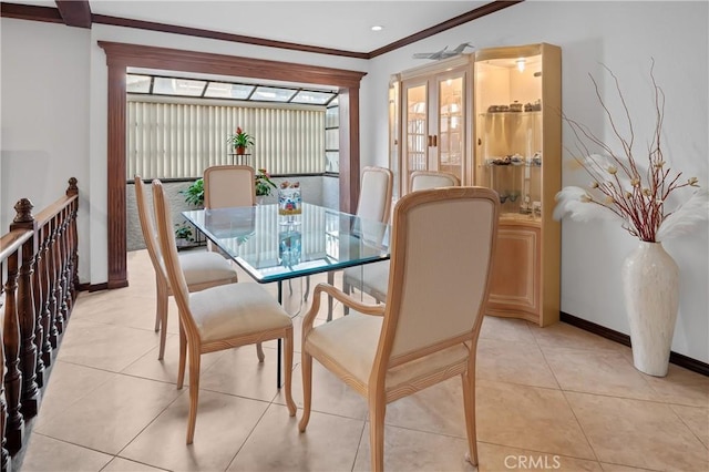 dining space featuring light tile patterned floors and crown molding