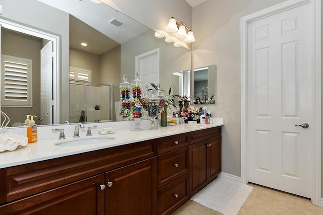 bathroom featuring vanity, tile patterned floors, and a shower with door