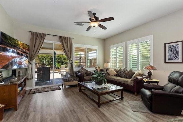 living room with hardwood / wood-style flooring and ceiling fan