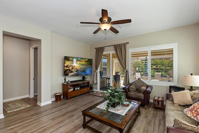 living room featuring ceiling fan and hardwood / wood-style floors