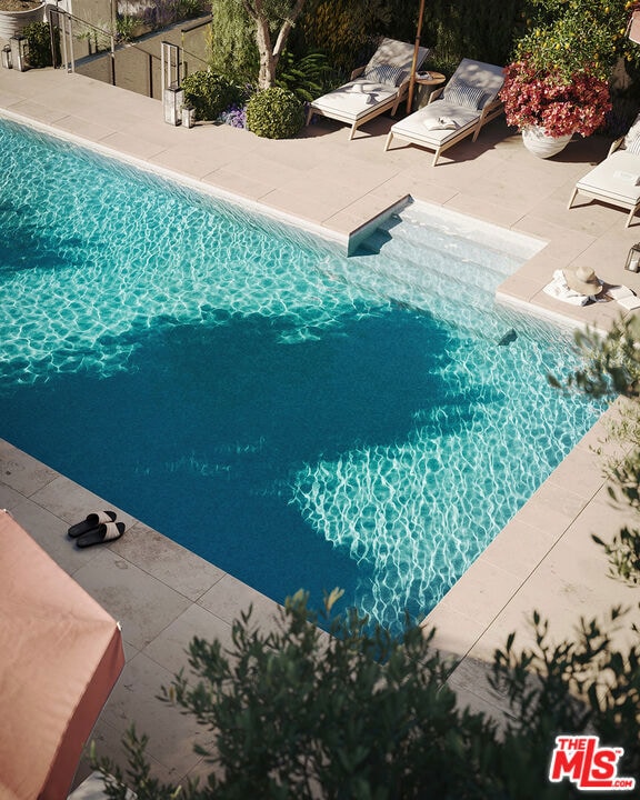 view of swimming pool featuring a patio area