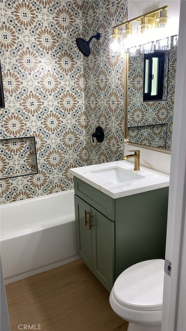 bathroom with wood-type flooring, toilet, and vanity