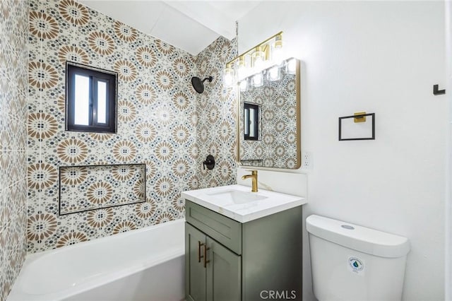 bathroom featuring toilet, vanity, and a tub to relax in