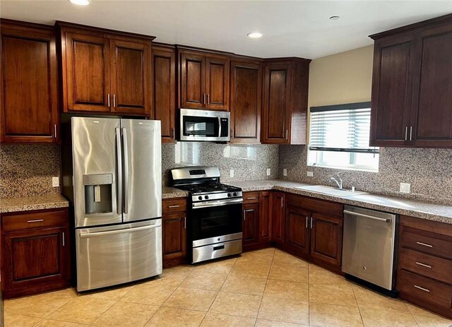 kitchen featuring tasteful backsplash, sink, and stainless steel appliances