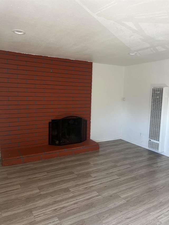 unfurnished living room featuring a fireplace and hardwood / wood-style floors