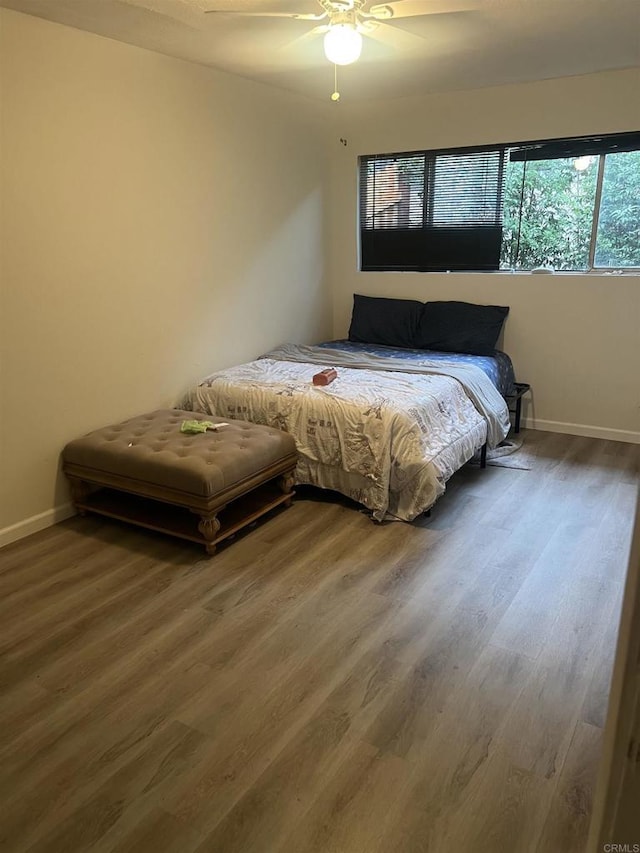 bedroom featuring ceiling fan and dark hardwood / wood-style flooring