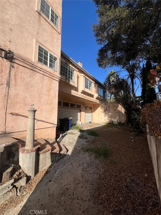 rear view of property featuring a garage