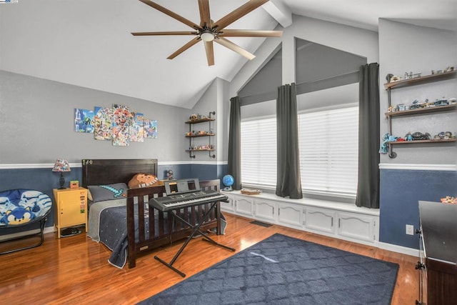 bedroom featuring light wood-type flooring, ceiling fan, and lofted ceiling with beams