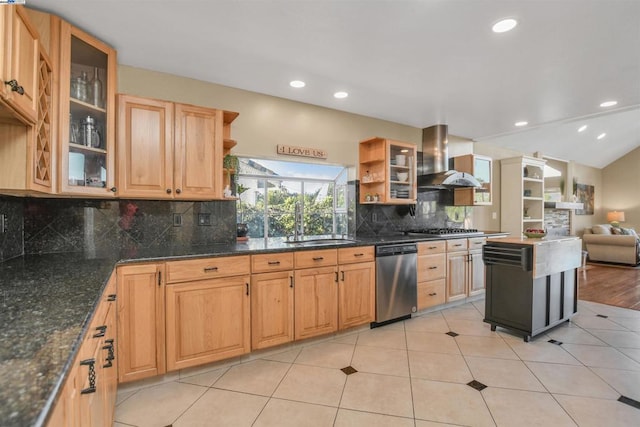 kitchen featuring wall chimney range hood, stainless steel appliances, dark stone counters, backsplash, and light tile patterned floors