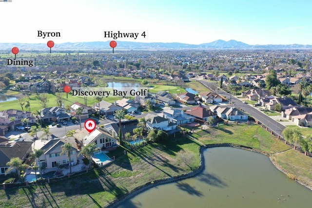 birds eye view of property with a water and mountain view