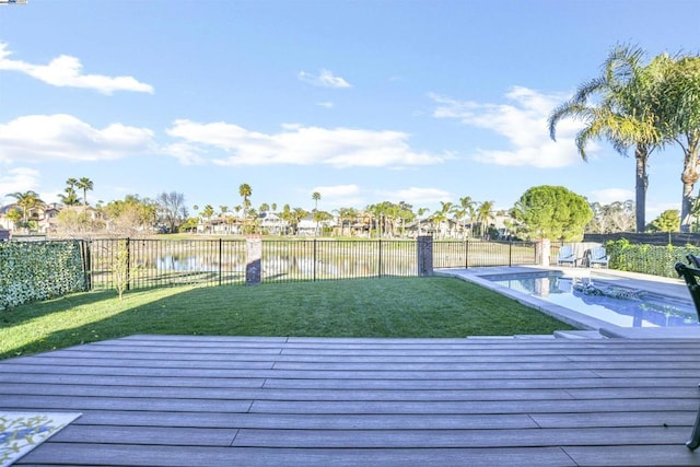 exterior space featuring a water view and a fenced in pool