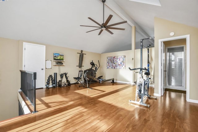 exercise room featuring ceiling fan, vaulted ceiling, and hardwood / wood-style flooring