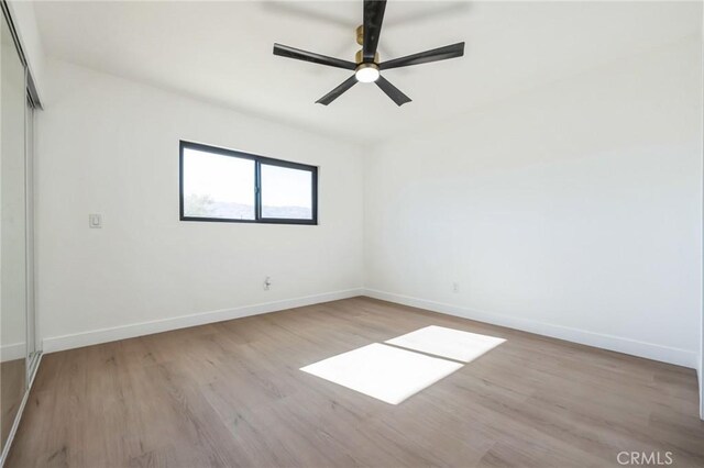 unfurnished room with light hardwood / wood-style floors and ceiling fan