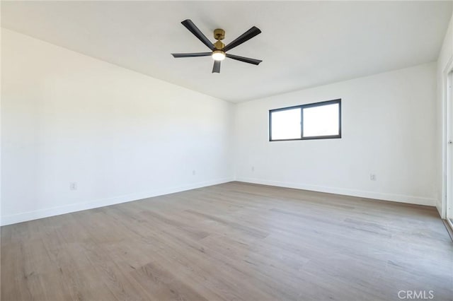 empty room with light wood-type flooring and ceiling fan