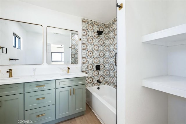 bathroom featuring double vanity, a healthy amount of sunlight, and a sink