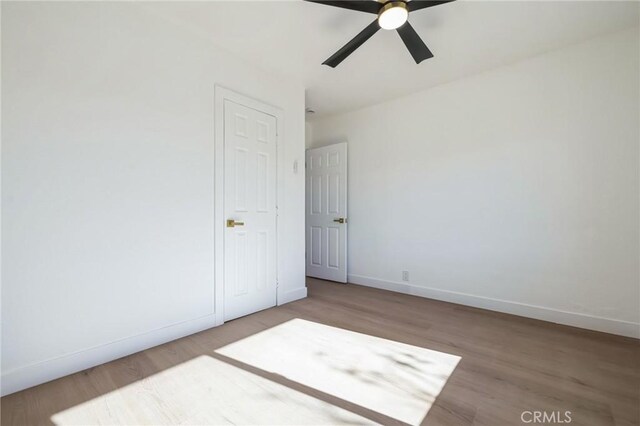 spare room featuring ceiling fan and hardwood / wood-style floors