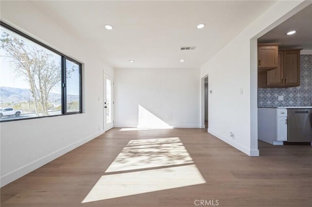 interior space with a mountain view and light wood-type flooring