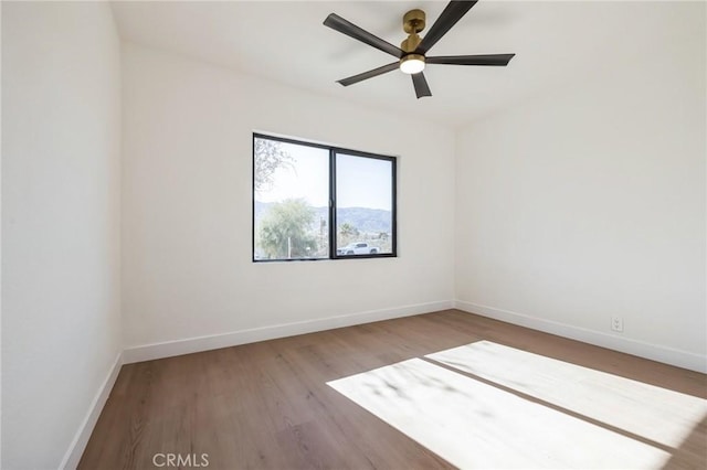 empty room with ceiling fan and hardwood / wood-style floors