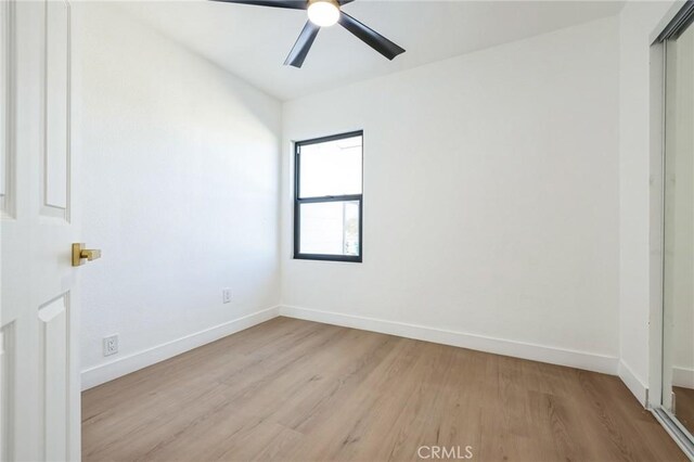 unfurnished room with ceiling fan and light wood-type flooring