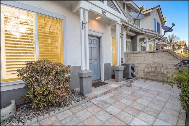 entrance to property with a patio and central AC