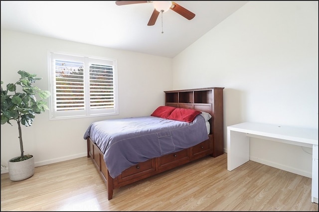 bedroom featuring ceiling fan, vaulted ceiling, and light wood-type flooring