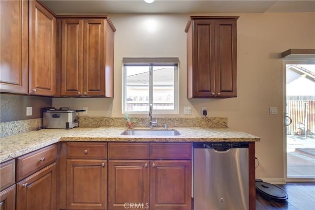 kitchen featuring sink, light stone countertops, and dishwasher