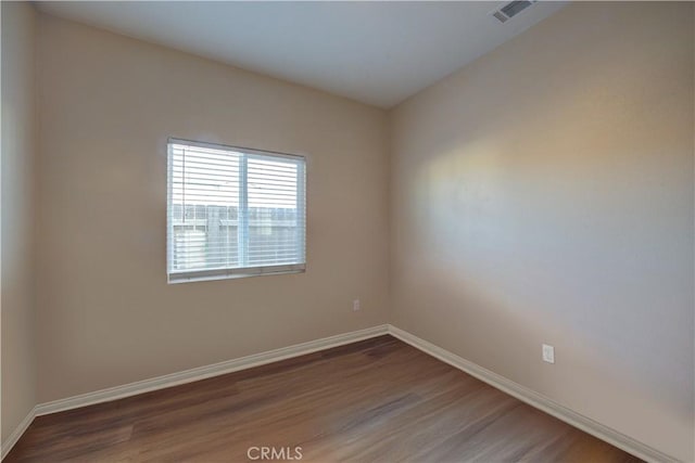 spare room with dark hardwood / wood-style flooring