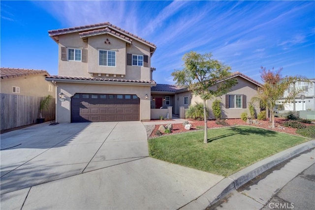 mediterranean / spanish-style house featuring a garage and a front yard