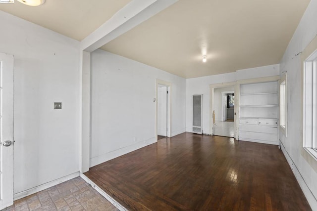 spare room featuring built in shelves