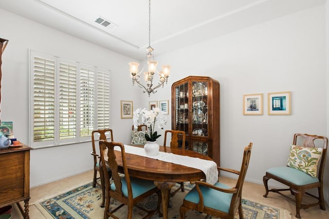 dining area featuring carpet floors and a chandelier