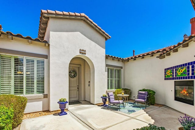 doorway to property with a patio area