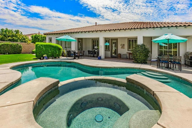 view of pool with a patio and an in ground hot tub