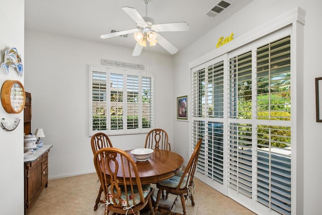 dining area with ceiling fan and light tile patterned flooring