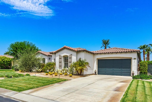 mediterranean / spanish house featuring a front yard and a garage