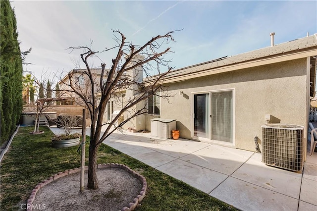 rear view of property featuring cooling unit and a patio