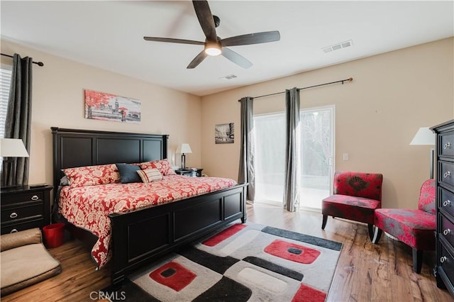 bedroom with ceiling fan, access to exterior, and hardwood / wood-style flooring