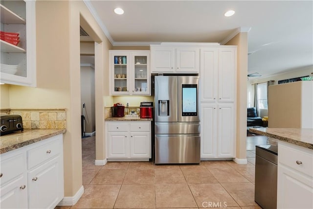 kitchen featuring stainless steel refrigerator with ice dispenser, light stone counters, white cabinetry, and light tile patterned flooring