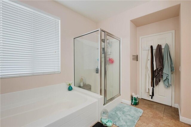 bathroom featuring shower with separate bathtub and tile patterned flooring