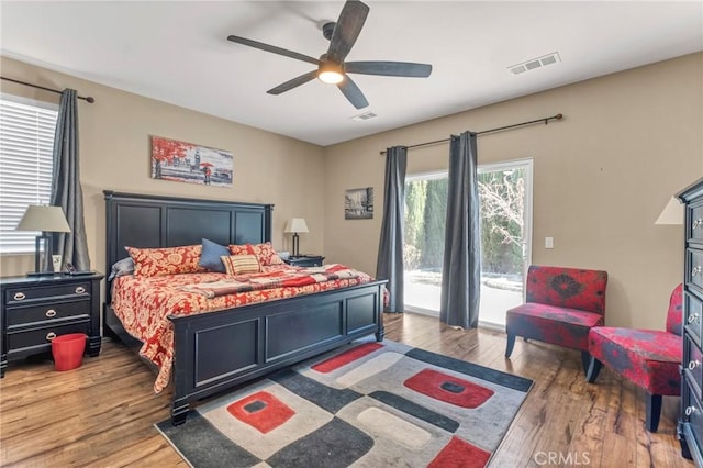 44620 Painted Desert St, Lancaster, CA 93536 - bedroom with visible vents, access to exterior, and wood finished floors