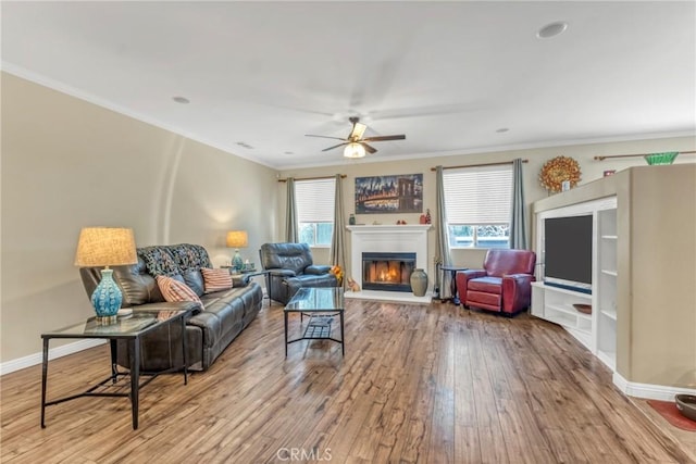 44620 Painted Desert St, Lancaster, CA 93536 - living room featuring hardwood / wood-style floors, ceiling fan, a glass covered fireplace, and a wealth of natural light