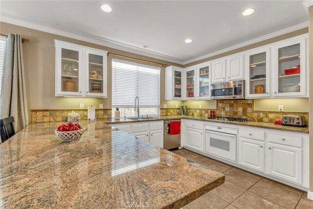 44620 Painted Desert St, Lancaster, CA 93536 - kitchen with ornamental molding, a peninsula, white cabinets, appliances with stainless steel finishes, and a sink
