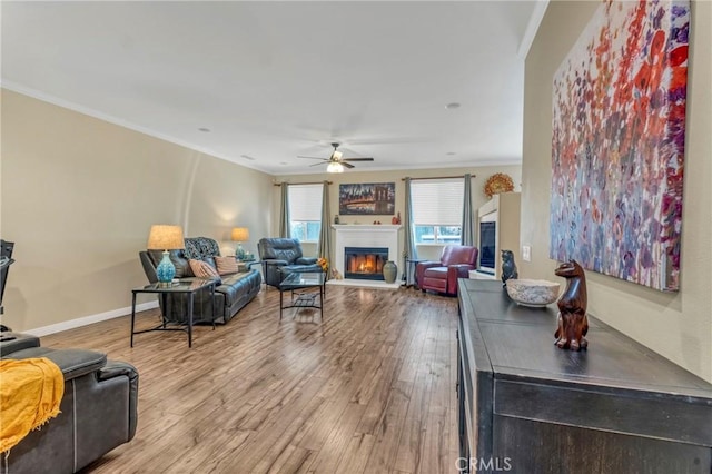 44620 Painted Desert St, Lancaster, CA 93536 - living area with crown molding, wood finished floors, ceiling fan, and a glass covered fireplace